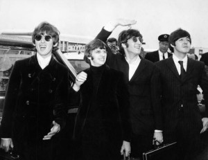 Pop group The Beatles, waving to screaming fans en route to Boston airport, America, from left to right, George Harrison, Ringo Starr, John Lennon and Paul McCartney, on August 12, 1966. (Photo by Daily Express/Archive Photos/Getty Images)